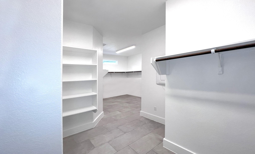 Oversized walk in closet off primary bed and bath