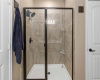 The ensuite bathroom also offers this large walk-in shower with gorgeous tile backsplash. 