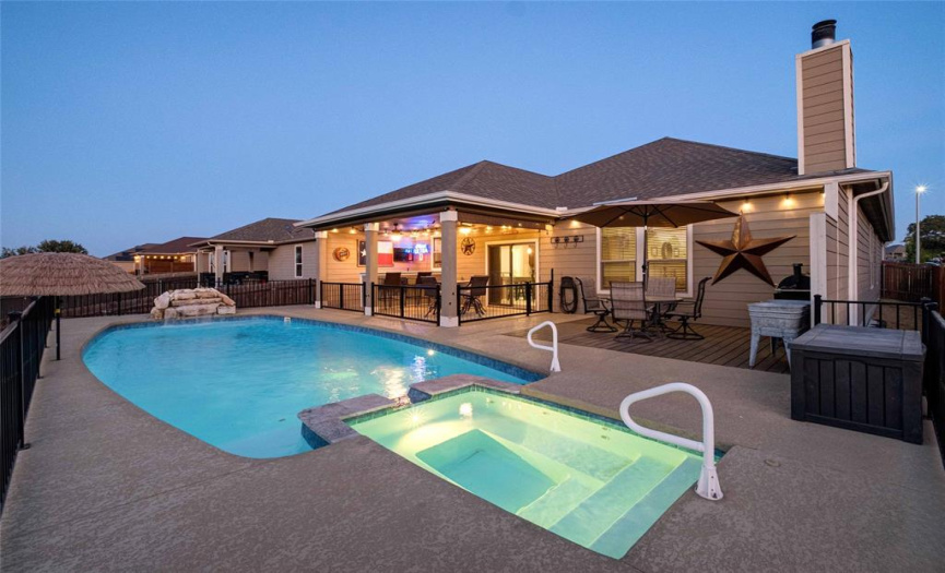 Welcome to your entertainer's backyard oasis with an in-ground pool and heated spa! 
