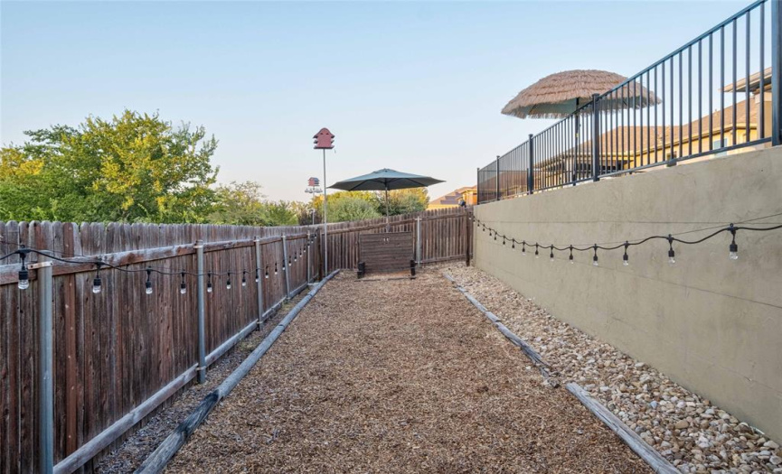Steps off the fenced pool deck lead down to a bonus fenced-in yard, which is great for pets and features a built-in horseshoe area and sustainable xeriscape. 