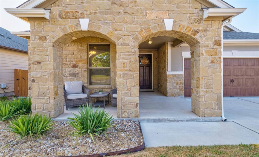 Your guests are greeted by a welcoming front porch with dual archways and space for a seating area or porch swing.