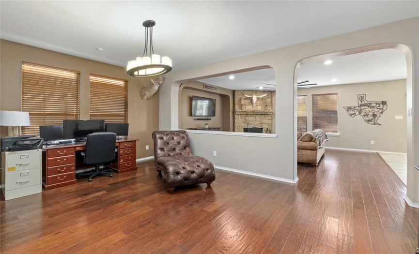 The centrally located formal dining room opens to the living area through a wide archway, which is perfect for entertaining.  The dining room is currently being used as an office.