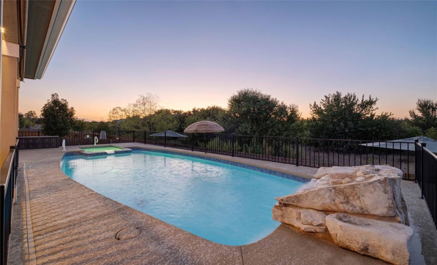 Finish out the summer in style with your own private backyard oasis overlooking a picturesque, wooded greenbelt. 