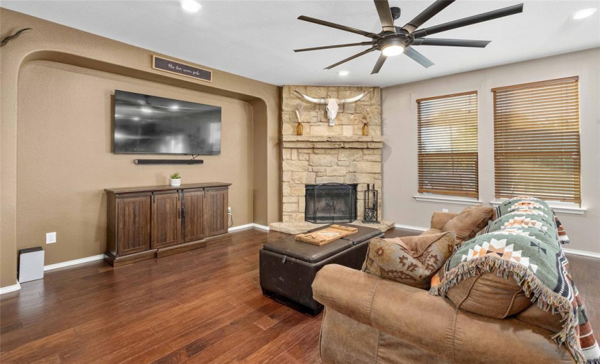 The focal centerpiece in the main living area is the impressive wood-burning fireplace nestled in a floor-to-ceiling limestone hearth with a natural stone mantel.