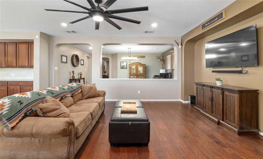 Featuring gorgeous hardwoods, sweeping archways, stylish modern fixtures including an oversized modern LED ceiling fan over the living room. 
