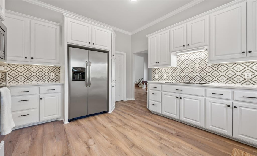 Beautiful flooring throughout the main level, designer backsplash, granite counters, stainless steel appliances, built in over and microwave, and much more!