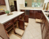 Convenient pull-outs are found in many of the lower cabinets in this large kitchen.
