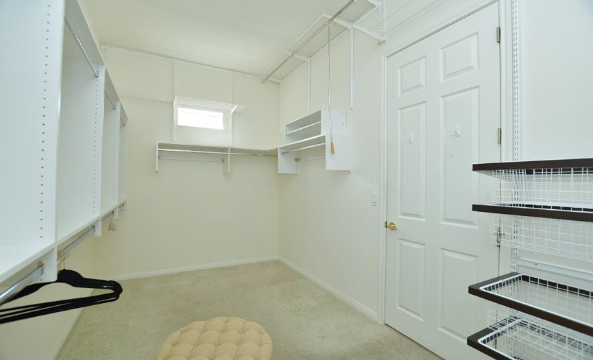 A nicely appointed walk-in closet is found off the primary bathroom.  A tiny window adds natural light.