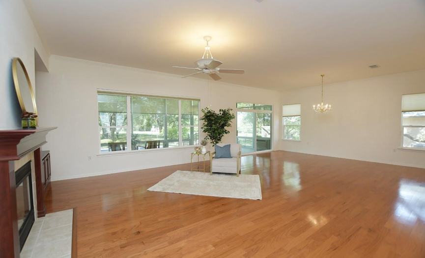 Ten-foot ceilings rimmed with crown molding along with wood floors provide a blank slate from which to begin your decorating choices for the combination living/dining room.  Pretty views of the pool can be seen out back!