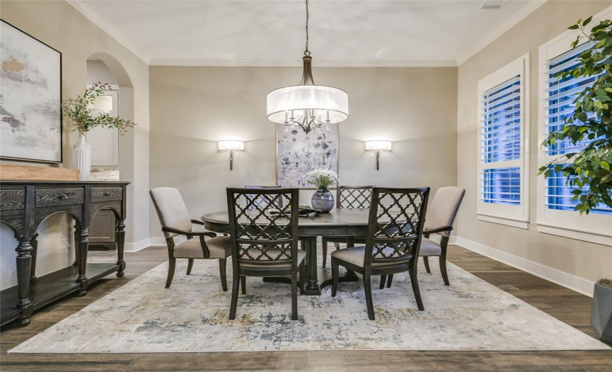 Greeted by a formal dining room with an enchanting chandelier and wall sconces, you’ll appreciate the exquisite entrance and warm welcome.  
