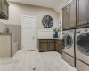 The main level, oversized laundry room offers a pet washing station, space for 2 refrigerators and access to the garages.