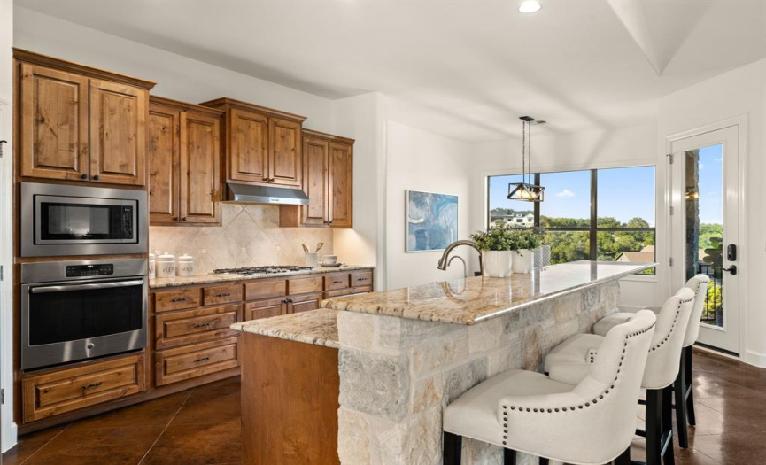 Deep pantry, eat at island, and newer appliances highlighted in this gourmet kitchen.