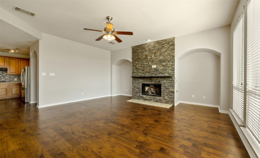 Family room off of kitchen with a fireplace.