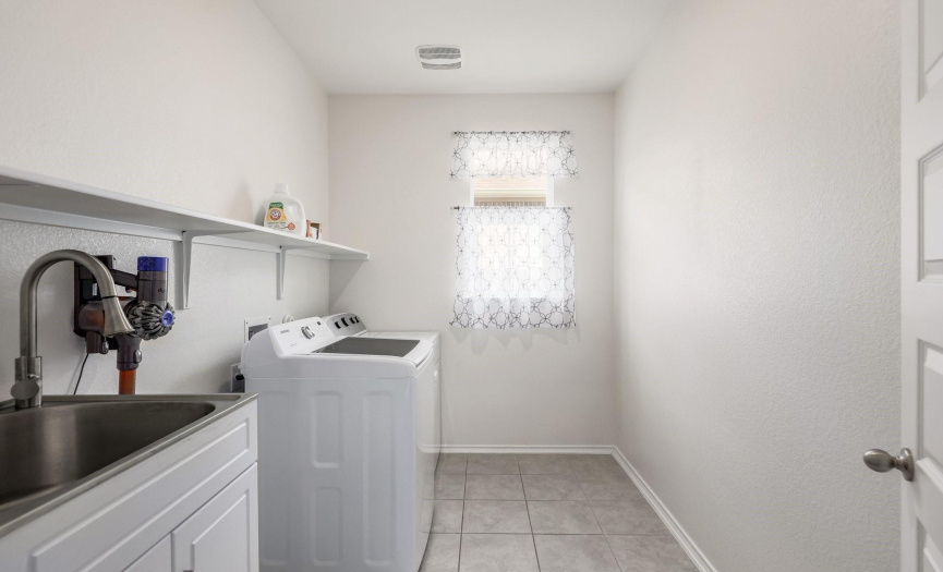 Main level Laundry room with storage & sink
