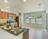 Granite and sparkling stainless create welcoming kitchen with convenient eat-in dining.