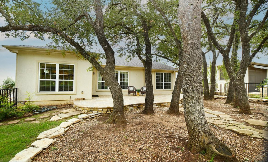 Low maintenance in this back yard with its native trees and stones.