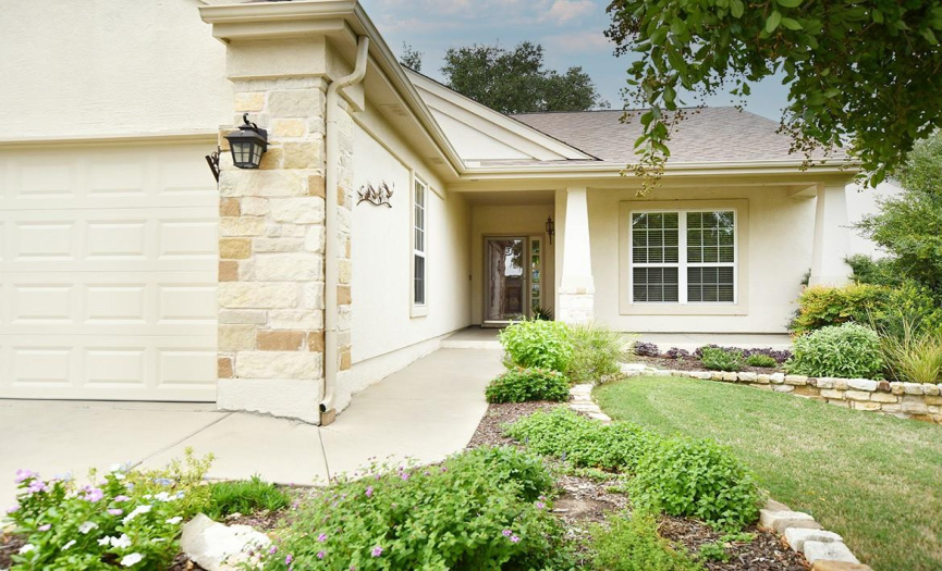 Stone and stucco surround this Classic Series Cambridge Plan as it backs to White Wing Golf Course - Hole 14.