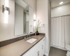 Full single vanity guest bathroom with combo tub/shower. Great lighting features. 