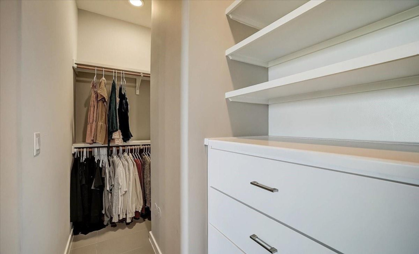 Two separate, built in dressers, with plenty of storage space above, and separate clothes hanging nooks. 