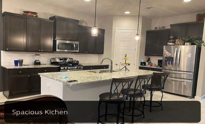 Experience the perfect synergy between the kitchen, dining, and living spaces in this beautifully designed home.
