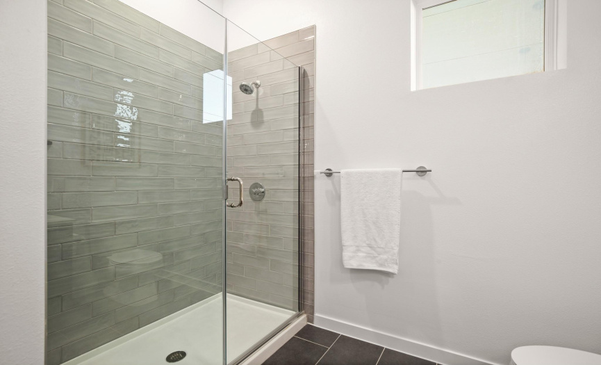 The primary bathroom features a frameless walk-in shower for your daily pampering.