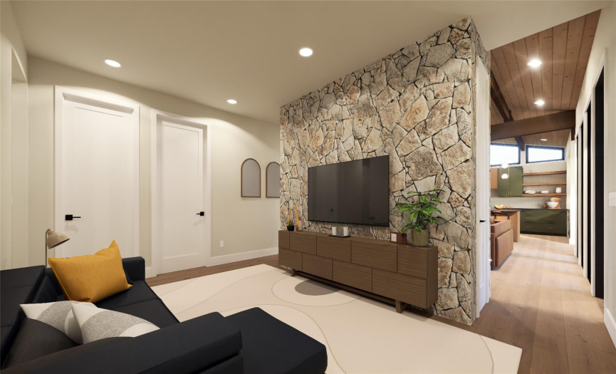 The family room, also based around the central stone column, creates a more intimate space to relax while maintaining a connection to the other living areas. The adjacent closets provide perfect storage for extra pillows and blankets, entertainment consoles, board games, and more!