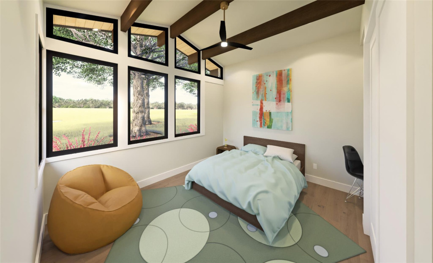 The second bedroom is nestled into the mature oak grove at the front of the home, complete with windows on multiple walls to enjoy the serene beauty.