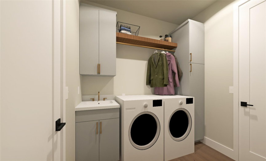 The centrally-located utility room includes double-entry from both sides of the home and features a full-height broom cabinet, shelving, and a utility sink. (Note: washer and dryer units are not included)