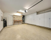 Workshop garage with epoxy floor and built-in cabinets.