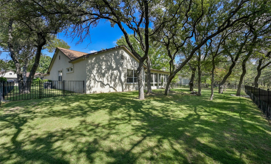 Mature Texas Live Oaks provide comfortable shade over fully fenced back yard.