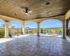 The lower level second covered patio has incredible views, access to the game room and pool area, creating the perfect outdoor/indoor entertaining space.