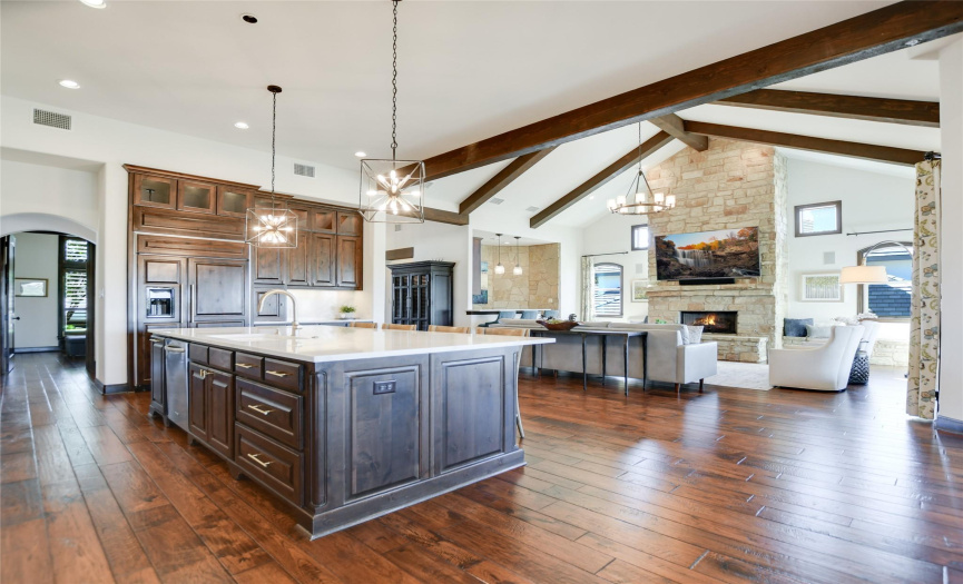 The recently renovated, open concept gourmet kitchen has MetroQuartz Calacatta countertops and “countersplash”, a walk-in pantry. custom cabinets, and countertop seating.