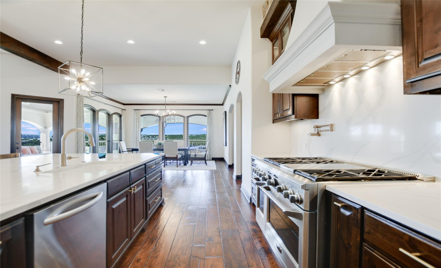 The chef's kitchen is a culinary dream come true, featuring top-of-the-line GE Monogram appliances, pasta faucet, and decorative gold hardware.