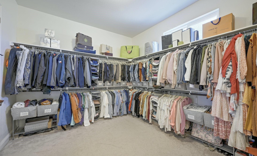 Extra large primary closet has plenty of space for everyone!