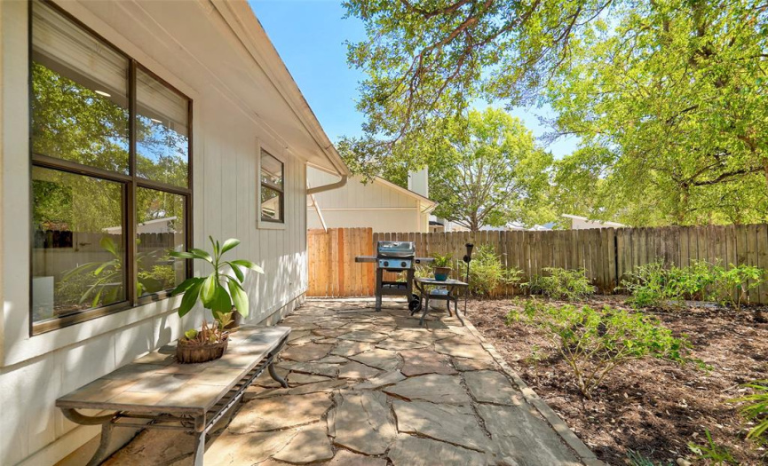 The large rear yard area is fully fenced and includes an Arizona Peach Flagstone patio ready for a BBQ.