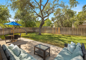 You'll love the tall and shady oak trees in this lovely backyard.