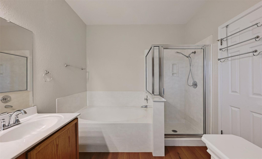 Primary en-suite bath with soaking garden tub and separate shower