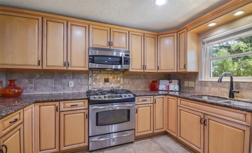  Enjoy the large kitchen with custom cabinets and granite countertops