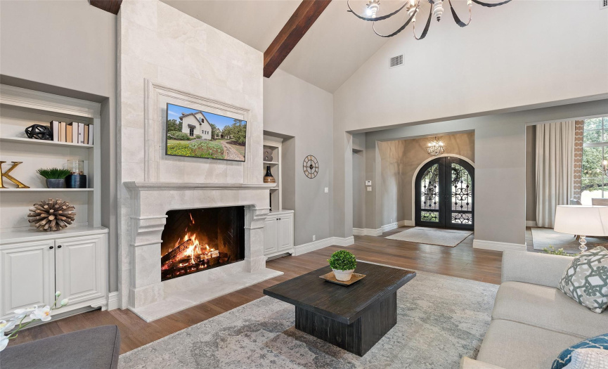 The centerpiece of the main living area is the stone fireplace surrounded by built-in cabinetry on either side. 
