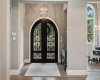 Iron double doors welcome you into the home. 