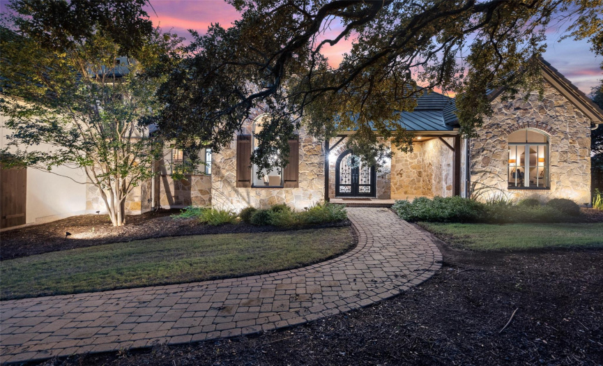 This timeless manor-style home is surrounded by grand oak trees throughout the 1.38 acre property. 