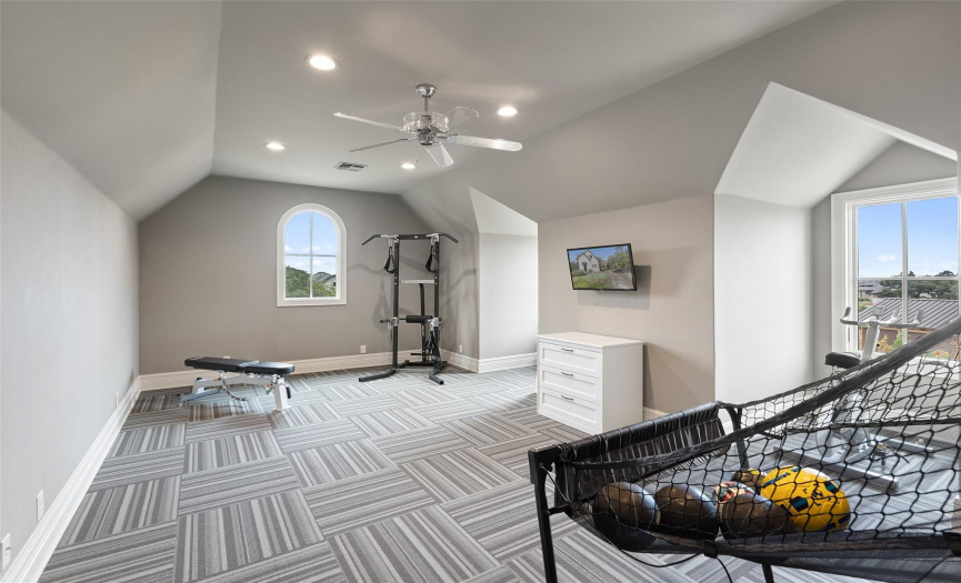 The oversized fifth bedroom is currently used as a hybrid workout and game room.