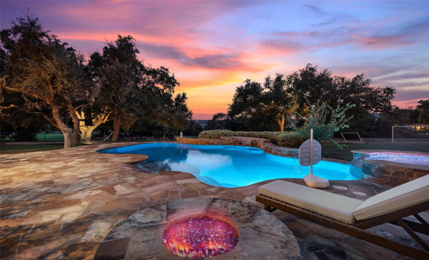 An elevated fire pit by the pool, perfect for chilly fall nights or roasting marshmallows in the summertime. 