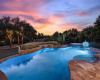 Ideal for entertaining, this pool offers a beach entry and fountain with attached hot tub. 