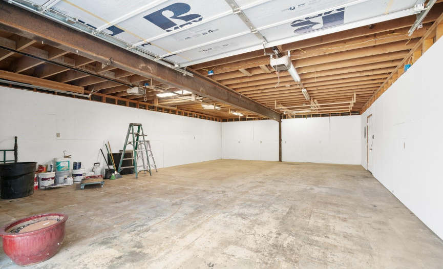 The large 2 car garage is seperate from the house and features a steel I-beam.It makes a great workshop. There is also a large unfinished space above the garage that would be a good office.