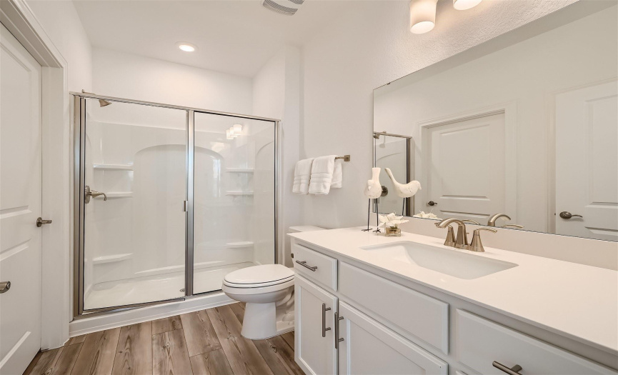 Guest bathroom includes walk in shower and oversized closet.