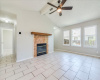 Bright open Family space with high ceilings, a cozy fireplace, and beautiful tile flooring.