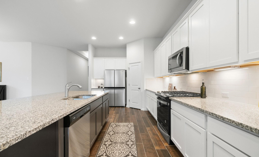 Abundant counter space and a subway tile backsplash make this kitchen both functional and stylish.