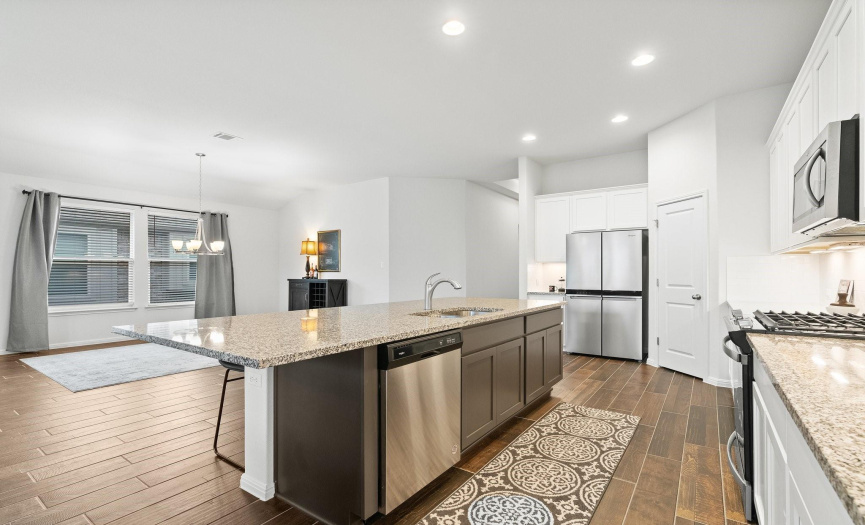 The kitchen's open concept design creates a seamless connection to the dining area, perfect for entertaining.