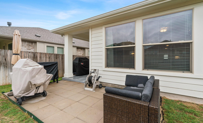 The uncovered patio area provides an ideal space for grilling or sunbathing in the privacy of your backyard.